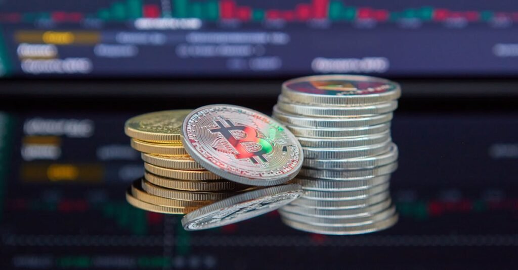 pexels-photo-7267609-7267609 Close-up of cryptocurrency coins with a market graph background.